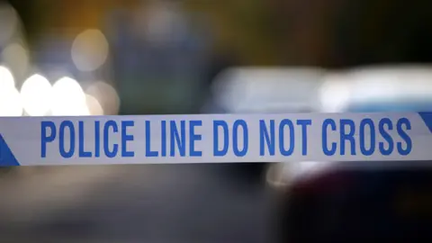 Tape. Text reads: 'POLICE LINE DO NOT CROSS'
