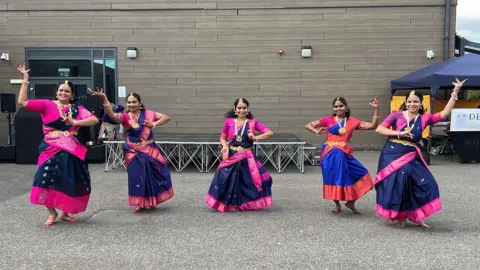 Group of five wearing traditional Indian dance practice saree