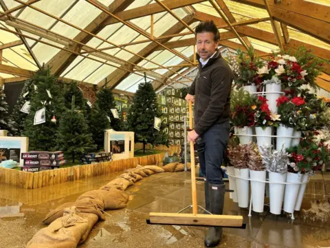 Andrew Turner/BBC Flooding inside Lathams of Potter Heigham