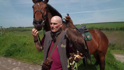 Martin Whitley with a horse and golden eagle