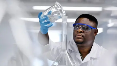 BBC Dr Ojodomo Achadu of Teesside University pouring liquid in a laboratory