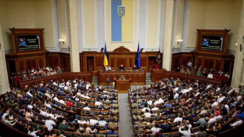 Reuters Ukrainian President Volodymyr Zelensky addresses the nation's parliament in Kyiv in 2023.