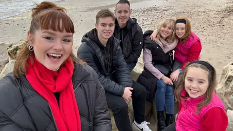 Simon Dunning Matthew Dunning with his sisters and parents on a beach