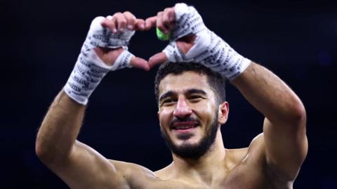 Ziyad 'Zizo' Almaayouf makes a heart sign with his hands after a fight