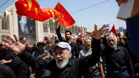 Reuters A man holds up his hands and wails in the crowd at the Grand Mosalla