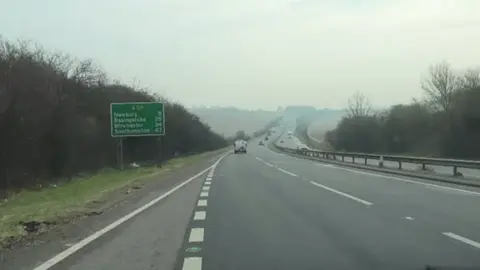 A shot taken through a car's windscreen as the driver pulls out onto the A34 from a slip road heading south towards Newbury