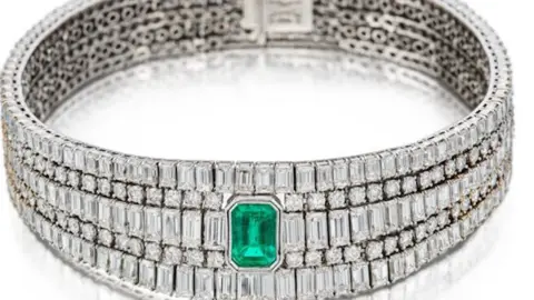 Metropolitan Police A bracelet or ring that appears to be diamond encrusted, with an emerald