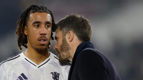 Action Images/Reuters Manchester United manager Michael Carrick (right) speaks to footballer Leny Yoro after a match. 