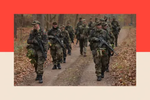 Getty Images New army recruits in Germany's armed forces, they patrol during basic training in a forest 
