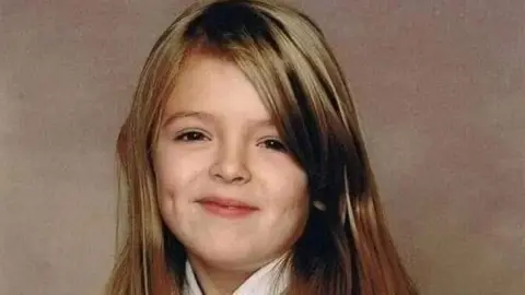 Trevor Bygate A smiling blonde Chloe looking directly at the camera when she was a young child