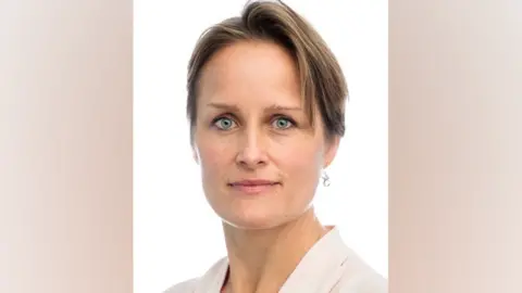 Frontal portrait of Blaise Metreweli. She is looking at the camera against a white background. 