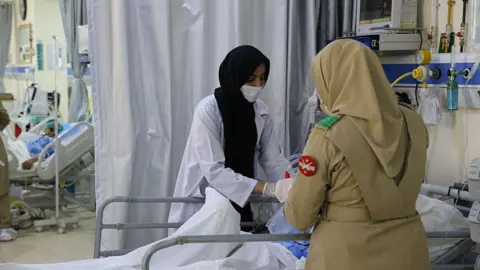 Students injured in a bomb attack on a school bus receive medical treatment in a hospital on May 23, 2025 in Balochistan province, Pakistan. 
