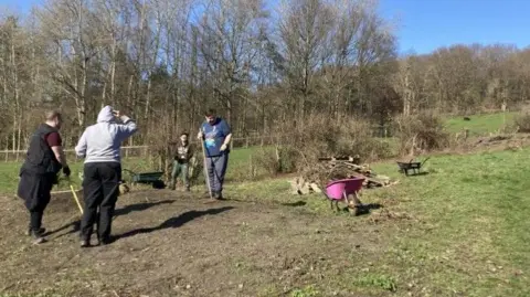 BBC/Cathy Minton Adults with learning difficulties working on a farm in Leeds, with animals in the background