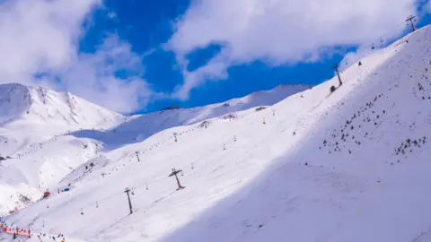 Getty Images Ski slopes and snow-covered mountain at Aston Ski Resort, in the Pirenhos Mountains, Huesca, Spain.