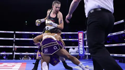 Matchroom Boxing Opponent Shannon Ryan stumbles in front of Emma Dolan in the boxing ring at Birmingham.