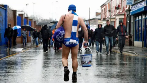 Getty Images Speedo Mick is seen arriving to the stadium prior to the Premier League match between Everton and Liverpool at Goodison Park on April 7, 2018 in Liverpool, England.