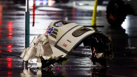 Reuters A plane panel - which includes two windows - is seen scattered on the floor on the accident site