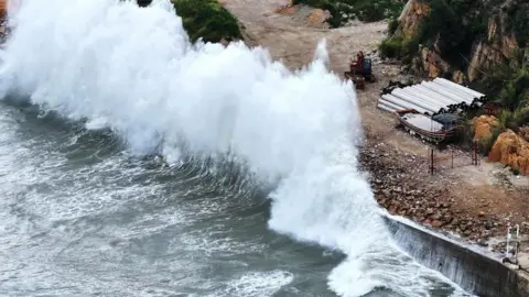 Reuters Huge waves crash on the coast of Huangqi in Lianjiang county, as Typhoon Dolphin approaches, in Fujian