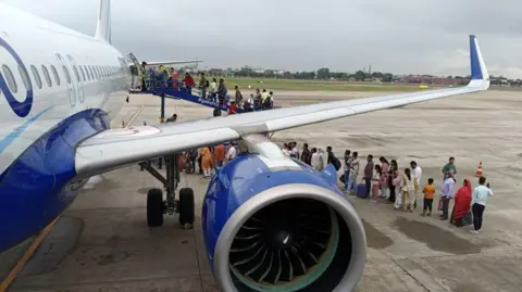 Getty Images Passengers line up to board an IndiGo Airlines flight at Jaipur International Airport in Rajasthan State, India, on September 7, 2024.