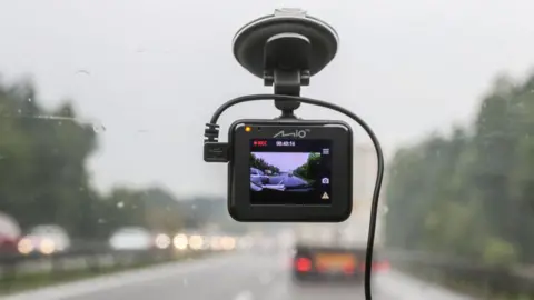 A dashcam in a car on a motorway.