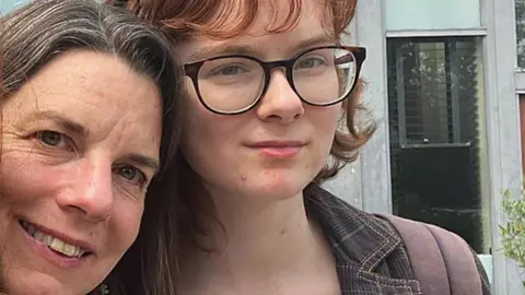 Clare Rogers A mum and daughter smiling into the camera