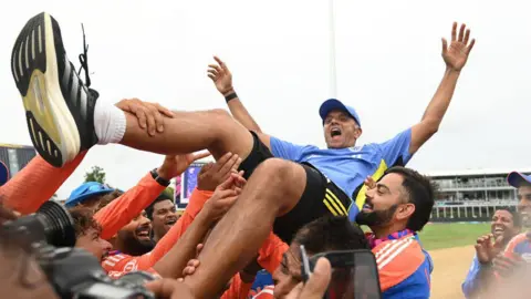 Getty Images BRIDGETOWN, BARBADOS - JUNE 29: Rahul Dravid, India head coach is thrown into the air after India won the ICC Men's T20 Cricket World Cup West Indies & USA 2024 Final match between South Africa and India at Kensington Oval on June 29, 2024 in Bridgetown, Barbados. (Photo by Philip Brown/Getty Images)