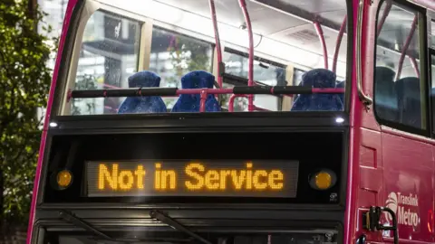 Pink Translink bus which says Not in service