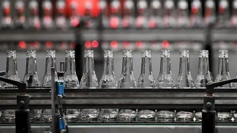 Getty Images Glass bottles on a conveyor belt.