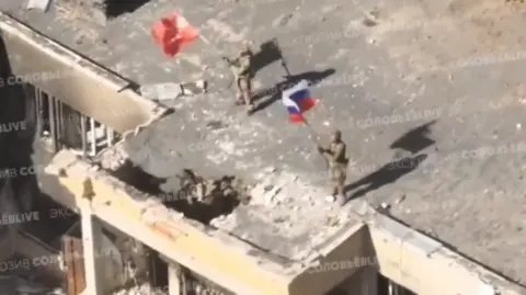 Pro-Kremlin military bloggers on Russian social media posted images of Russian flags flying over abandoned buildings.