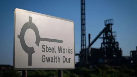 Getty Images A road sign for Port Talbot steelworks with an out of focus steelworks in the background.