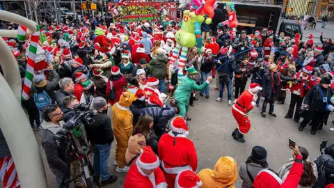 People take the streets of New York City for SantaCon