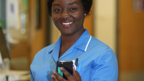A nurse holdin a mobile phone