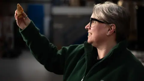 Tony Jolliffe BBC Dr Sara Machin, the finds lead for a consortium of archaeologists working on the post excavation archive holding a Paleolithic hand axe