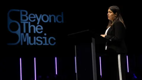 Nici Eberl Culture Secretary Lisa Nandy speaking with a Beyond the Music logo behind her