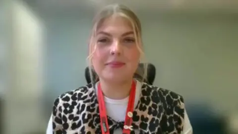 Hannah Lindsay, GTR's Safety and Security Improvement Manager, speaking during an interview. She is blonde and wears a leopard print jacket.
