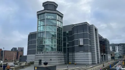 General view of the Royal Armouries museum in Leeds, with its Hall of Steel glass tower in the foreground.