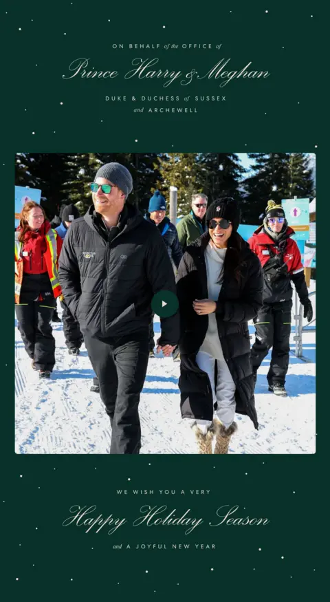 Duke and Duchess of Sussex A dark green card with gold lettering and a photo of harry and meghan linking arms as they walk on snow. They are wearing coats and sunglasses and are laughing. there are people behind them also walking and it is sunny. 