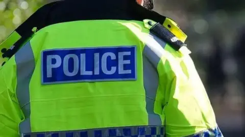 The back of a police officer's jacket. 