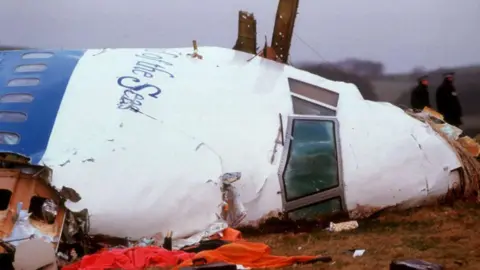 Officials inspect the wreckage of Pan Am flight 103 December 21, 1988 in Lockerbie, Scotland.
