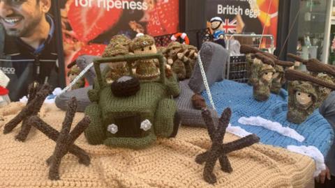 Knitted scenes from D-Day on top of a postbox