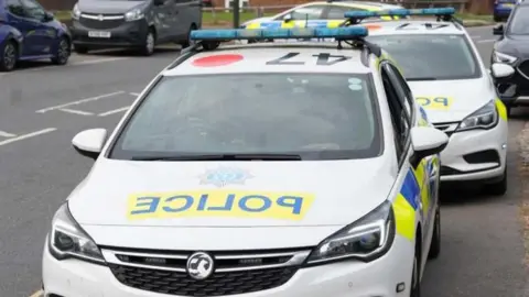 Three police cars arriving at the scene