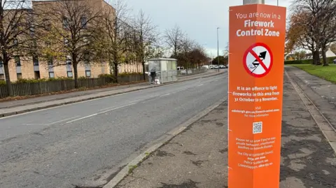 An orange sign at the start of the FCZ in Niddrie, Edinburgh.
