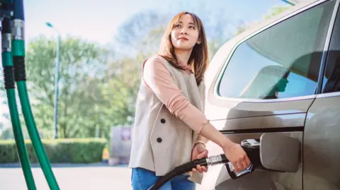 Woman filling car
