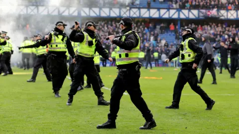 Officers had to keep rival fans apart after the final whistle following Rangers' Scottish Cup match against Celtic at Ibrox in March