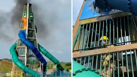 Wooden frame with green and blue tube slide spiralling down with flames coming from its top section.
