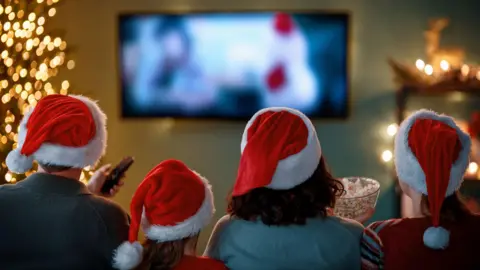 Getty Images A family watching TV together