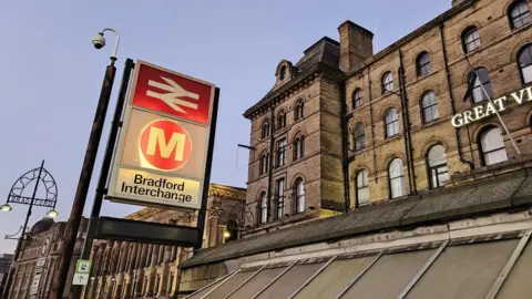 Aisha Iqbal/BBC The Bradford Interchange sign pictured at dusk 