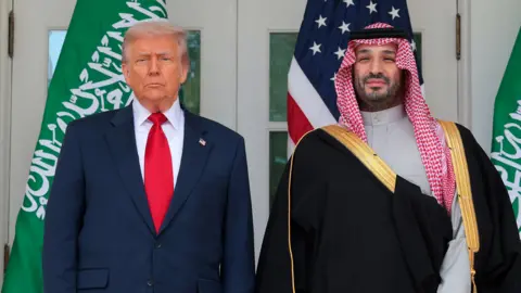 Trump and  Saudi Crown Prince Mohammed bin Salman stand next to each other  looking out towards the camera with serious expressions at the White House in Washington DC last November