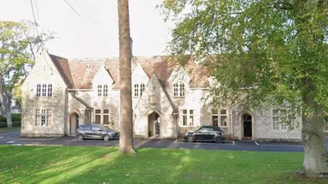 A Google Maps street view of the avon coroners court, which is an older building made up of with several large stone porch entrances. 