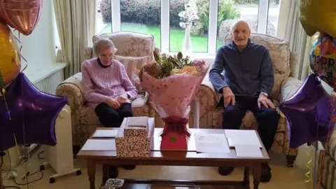 SUPPLIED An elderly couple sat in a living room